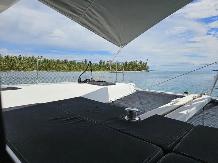 Lucky Vibes Yacht Photos Pics 2018 Lagoon 42 catamaran deck with ocean view and tropical island backdrop.