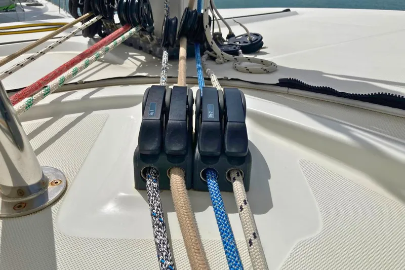 Lucky Vibes Yacht Photos Pics Rope clutches on a 2018 Lagoon 42 catamaran deck, securing colorful sailing lines.