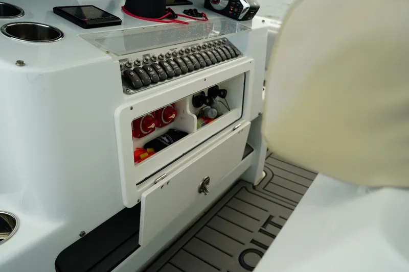  Yacht Photos Pics 2023 Andros 32 Offshore boat console with storage compartments and control panel.