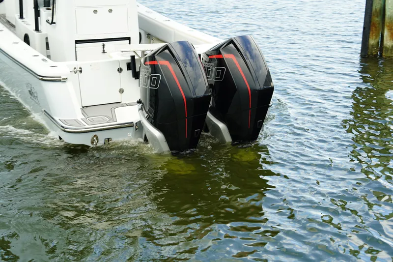  Yacht Photos Pics 2023 Andros 32 Offshore boat with dual outboard motors in water.