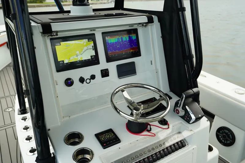  Yacht Photos Pics 2023 Andros 32 Offshore boat dashboard with navigation screens and steering wheel.