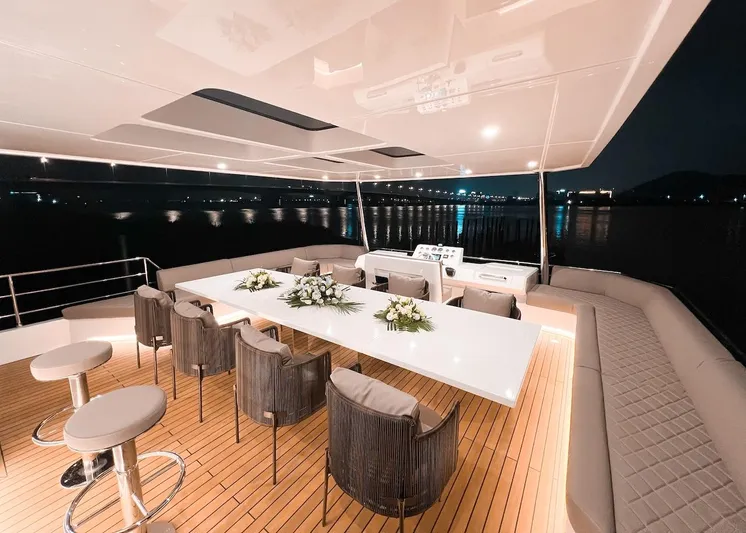 Diamond Yachts Ef56 Yacht Photos Pics Luxurious 2024 Catamaran Diamond Yachts EF56 with elegant outdoor dining area at night.