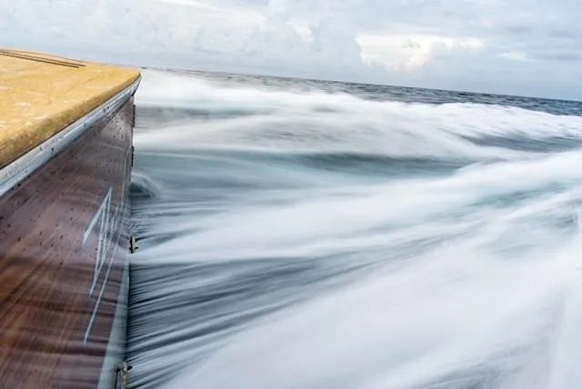 Bel Esprit Yacht Photos Pics Jim Smith Custom 66 Sportfish slicing through ocean waves, 1999 model.