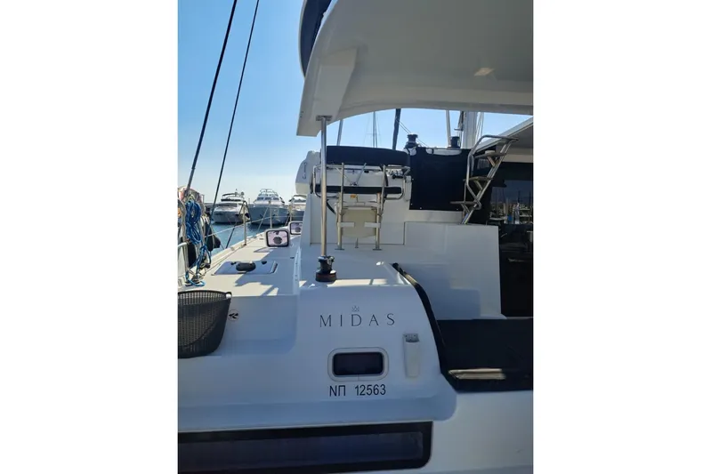  Yacht Photos Pics 2020 Lagoon 42 catamaran docked, featuring spacious deck and modern design.