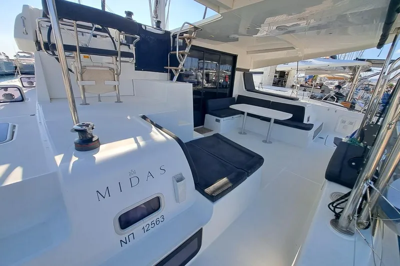  Yacht Photos Pics 2020 Lagoon 42 catamaran with spacious deck, seating area, and modern design.