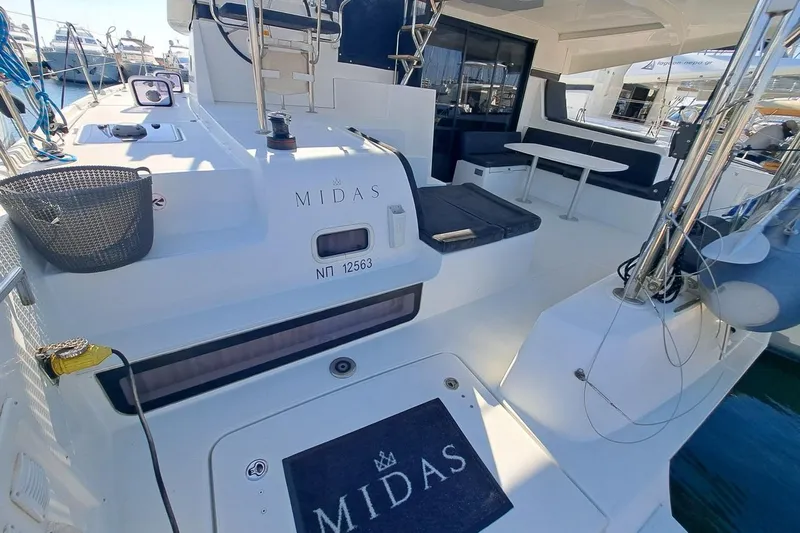  Yacht Photos Pics Lagoon 42 catamaran, 2020 model, featuring spacious deck and seating area in marina.