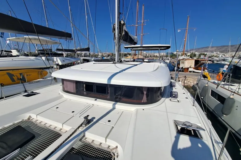  Yacht Photos Pics 2020 Lagoon 42 catamaran docked at marina under clear blue sky.