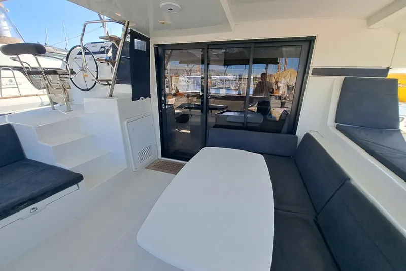  Yacht Photos Pics Spacious deck of 2020 Lagoon 42 catamaran with seating and helm station.