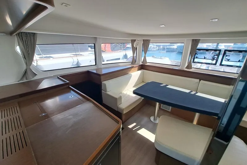  Yacht Photos Pics Interior of 2020 Lagoon 42 catamaran with modern seating and large windows.