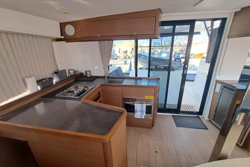 Yacht Photos Pics Modern kitchen interior of 2020 Lagoon 42 catamaran with sleek design and outdoor view.