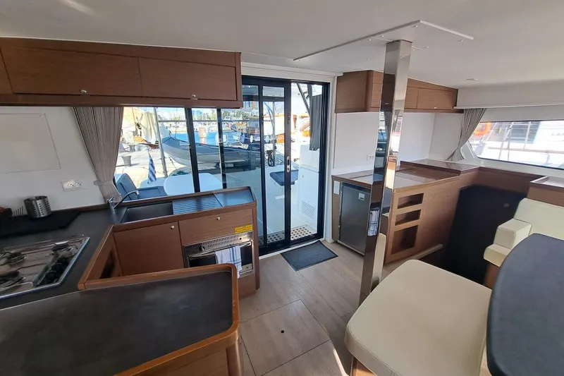  Yacht Photos Pics Interior of 2020 Lagoon 42 catamaran with modern kitchen and seating area.
