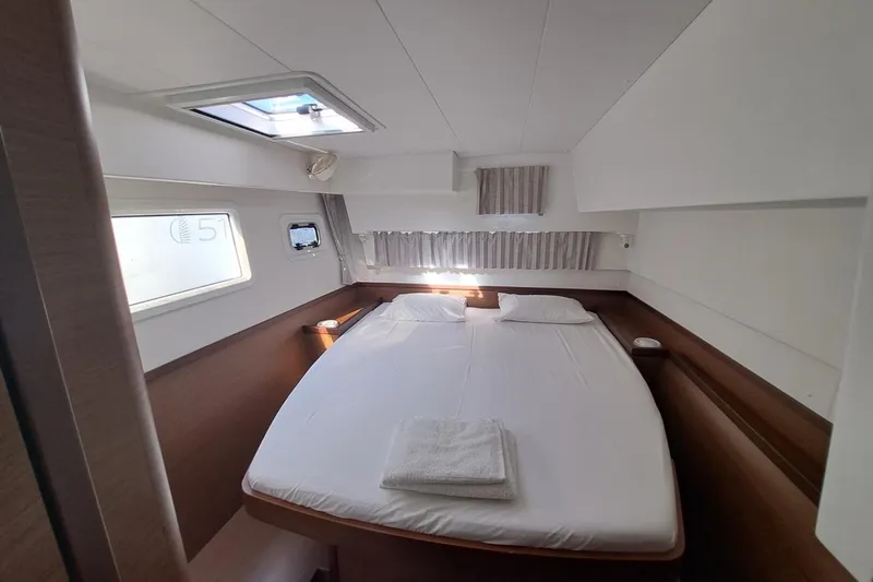  Yacht Photos Pics Luxurious cabin interior of 2020 Lagoon 42 catamaran with double bed and natural light.