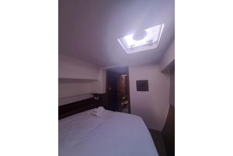  Yacht Photos Pics Interior cabin of 2020 Lagoon 42 catamaran with bed and skylight.