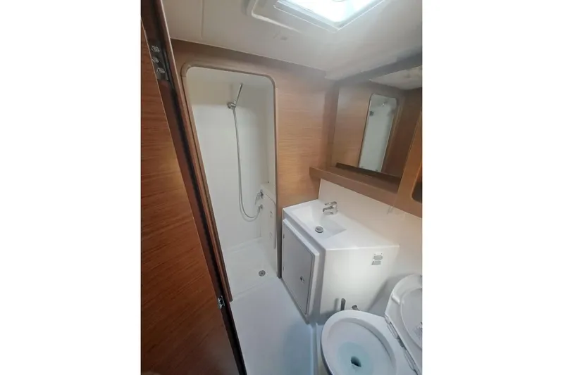  Yacht Photos Pics Bathroom interior of 2020 Lagoon 42 catamaran with shower, sink, and toilet.