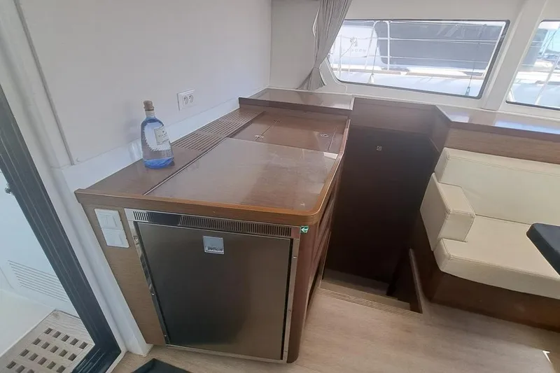  Yacht Photos Pics Interior of 2020 Lagoon 42 yacht with kitchenette and seating area.