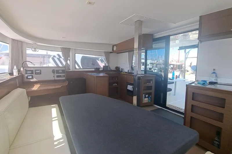  Yacht Photos Pics Interior of 2020 Lagoon 42 catamaran with modern kitchen and seating area.