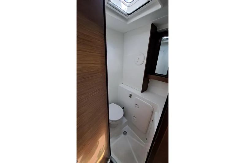  Yacht Photos Pics Bathroom interior of 2020 Lagoon 42 catamaran with modern fixtures and skylight.
