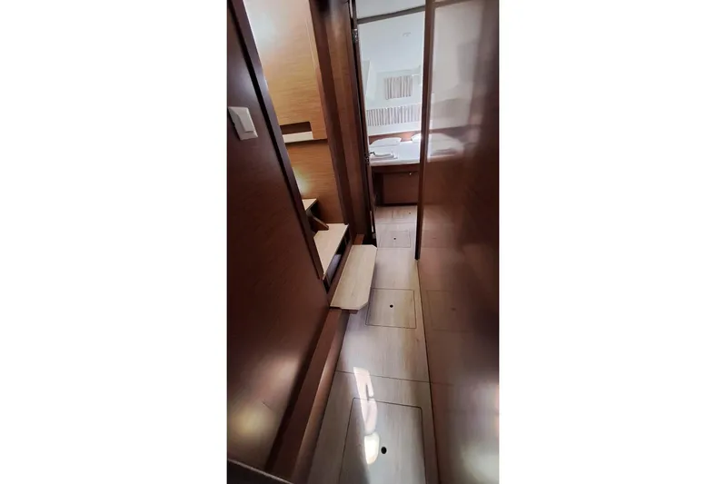  Yacht Photos Pics Interior hallway of 2020 Lagoon 42 catamaran, featuring wooden finishes and modern design.