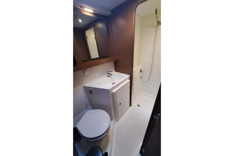 Yacht Photos Pics Modern bathroom in 2020 Lagoon 42 yacht, featuring shower, sink, and toilet.