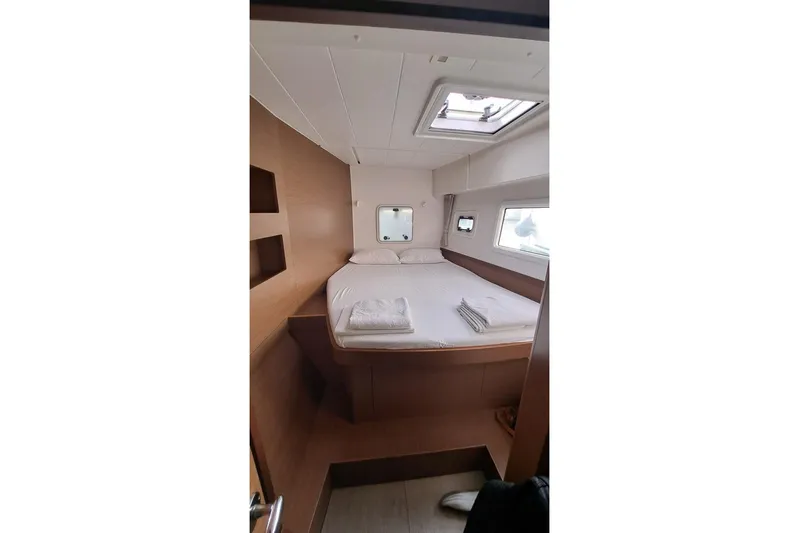  Yacht Photos Pics Interior cabin of 2020 Lagoon 42 catamaran with bed and windows.