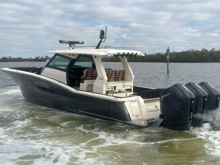  Yacht Photos Pics 2023 Scout 425 LXF boat with four engines cruising on a lake.