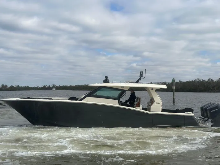  Yacht Photos Pics 2023 Scout 425 LXF boat cruising on a cloudy day.