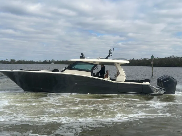  Yacht Photos Pics 2023 Scout 425 LXF boat cruising on a cloudy day.