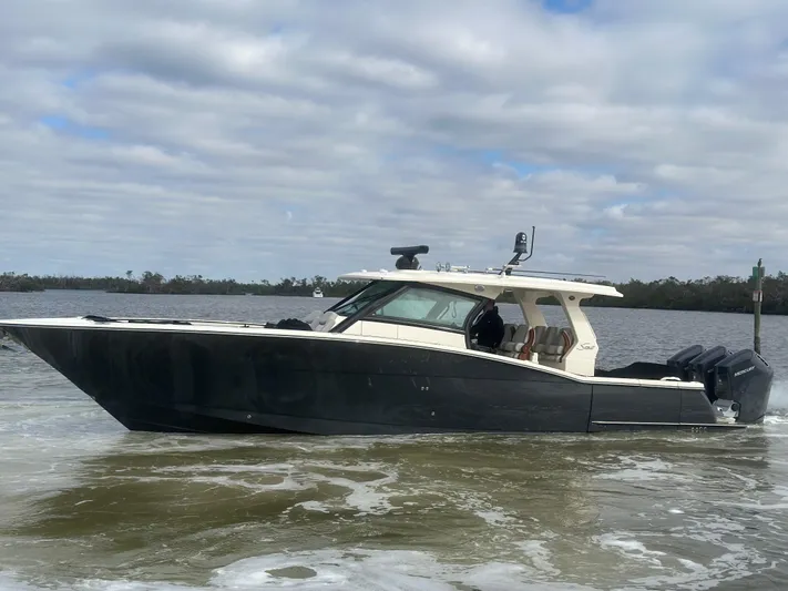  Yacht Photos Pics 2023 Scout 425 LXF boat cruising on a cloudy day.