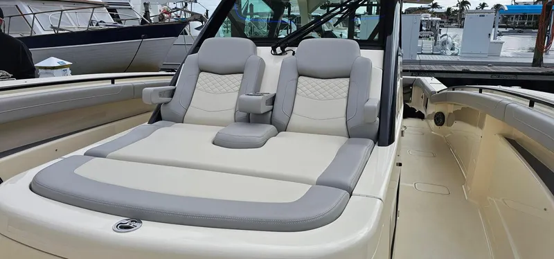  Yacht Photos Pics 2023 Scout 425 LXF luxury boat seating area with plush cushions.