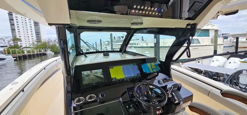  Yacht Photos Pics 2023 Scout 425 LXF boat cockpit with advanced navigation system and steering wheel.