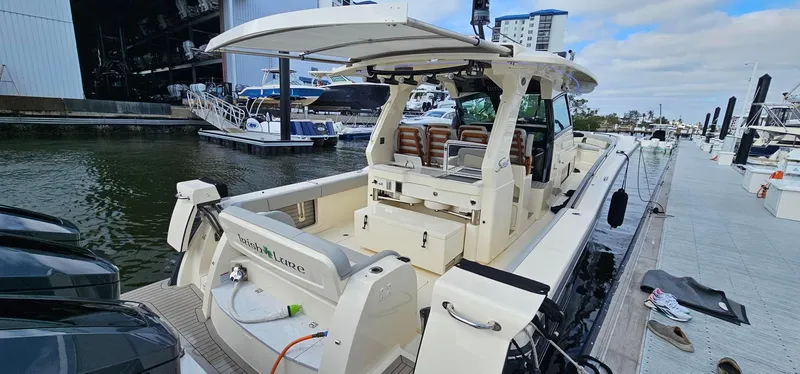  Yacht Photos Pics 2023 Scout 425 LXF luxury boat docked at marina, showcasing sleek design and modern features.