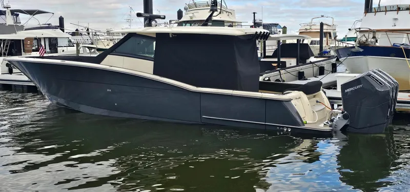  Yacht Photos Pics 2023 Scout 425 LXF boat docked in marina, featuring sleek design and powerful outboard engines.