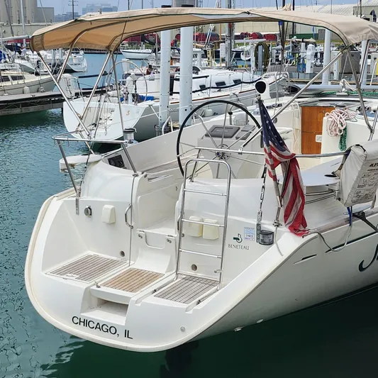 Scot-free Yacht Photos Pics 1999 Beneteau Oceanis 461 sailboat docked in Chicago marina with American flag.