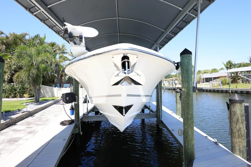  Yacht Photos Pics 2019 Boston Whaler 330 Outrage boat docked under a canopy.