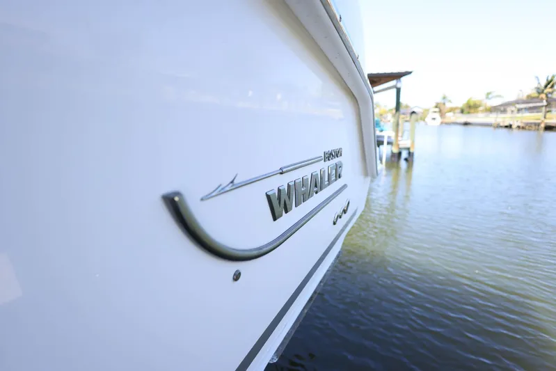  Yacht Photos Pics 2019 Boston Whaler 330 Outrage boat docked by the water.