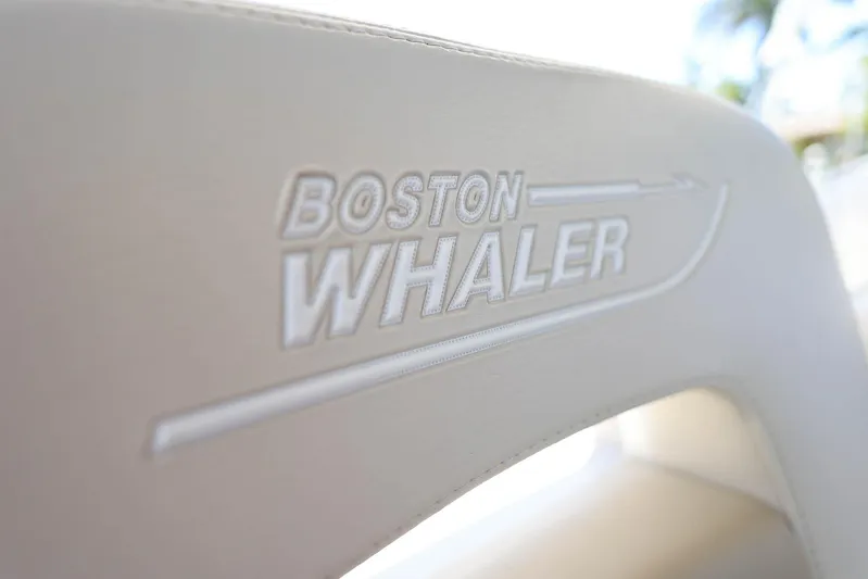 Yacht Photos Pics Close-up of embossed Boston Whaler logo on 2019 330 Outrage boat seat.