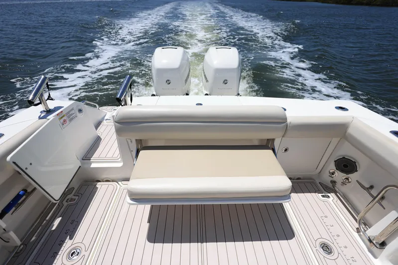  Yacht Photos Pics 2019 Boston Whaler 330 Outrage boat with twin engines and rear seating on open water.