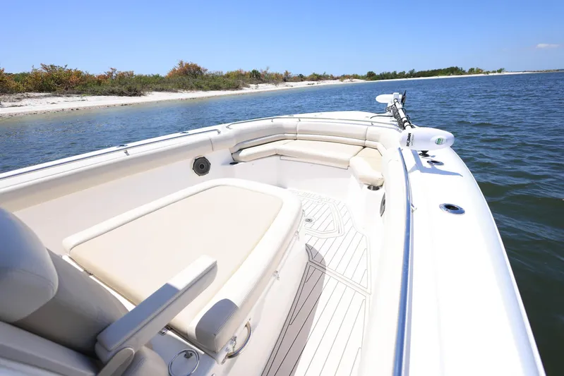 Yacht Photos Pics 2019 Boston Whaler 330 Outrage boat near a scenic shoreline.