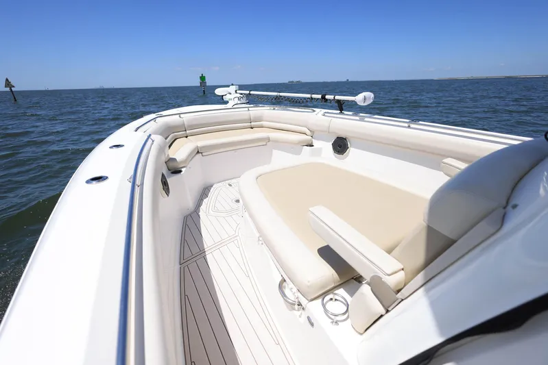  Yacht Photos Pics 2019 Boston Whaler 330 Outrage boat on open water, featuring spacious seating.