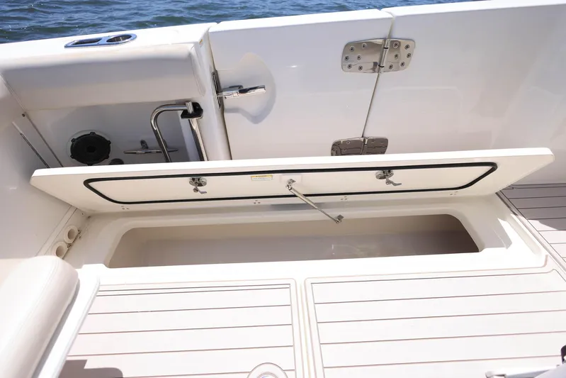  Yacht Photos Pics 2019 Boston Whaler 330 Outrage boat deck with open storage compartment.
