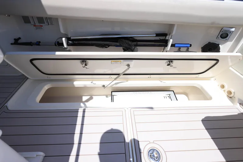  Yacht Photos Pics 2019 Boston Whaler 330 Outrage storage compartment with open hatch and organized equipment.