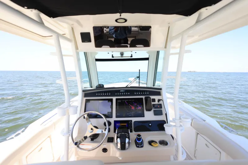  Yacht Photos Pics 2019 Boston Whaler 330 Outrage helm with advanced navigation system on open water.