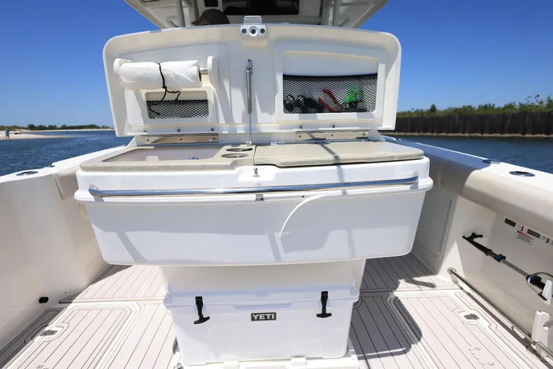  Yacht Photos Pics 2019 Boston Whaler 330 Outrage boat deck with storage and Yeti cooler.
