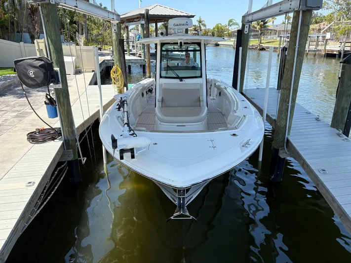  Yacht Photos Pics 2019 Boston Whaler 330 Outrage docked in a marina, front view.
