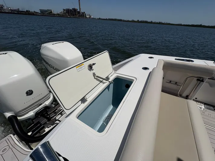  Yacht Photos Pics 2019 Boston Whaler 330 Outrage boat with open storage compartment and twin engines on water.