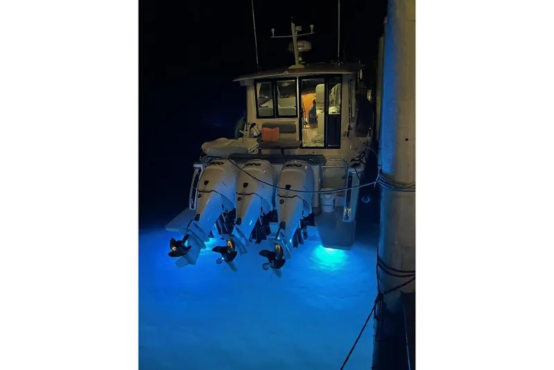 American Girl Yacht Photos Pics 2021 Back Cove 390 boat with illuminated outboard motors at night.