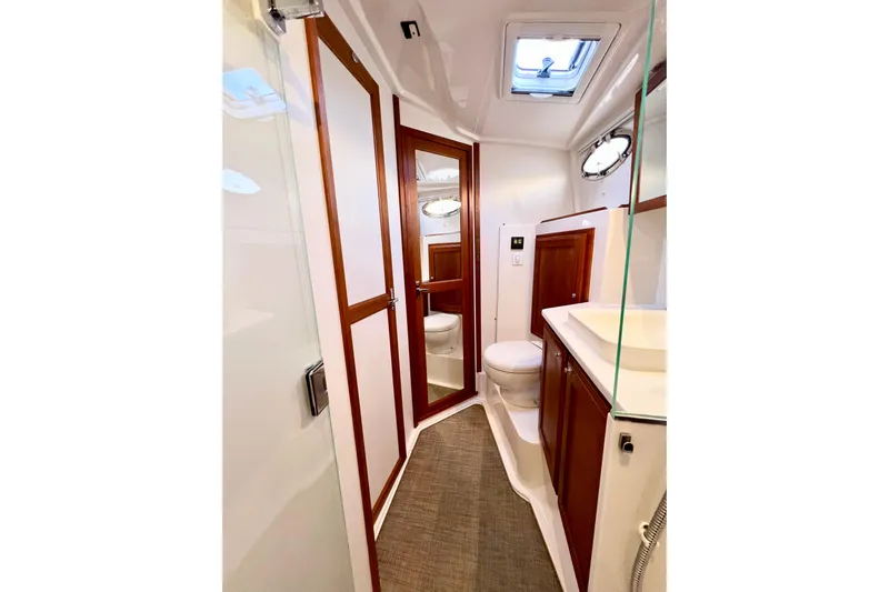 American Girl Yacht Photos Pics Luxurious bathroom in 2021 Back Cove 390 yacht with wood accents and modern fixtures.