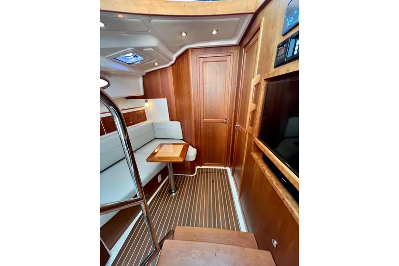 American Girl Yacht Photos Pics Interior of 2021 Back Cove 390 yacht with wood paneling and seating area.