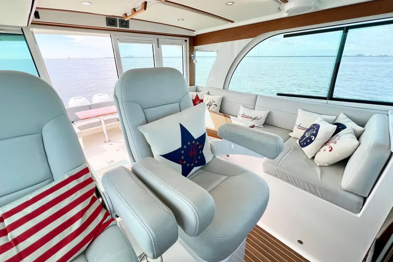 American Girl Yacht Photos Pics Interior of 2021 Back Cove 390 yacht with plush seating and nautical-themed pillows.