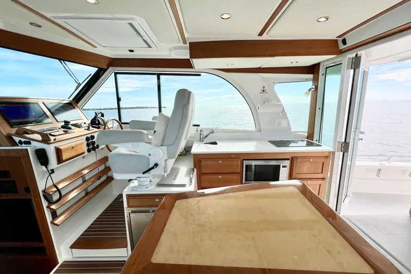 American Girl Yacht Photos Pics Interior of 2021 Back Cove 390 yacht with helm, kitchen, and ocean view.